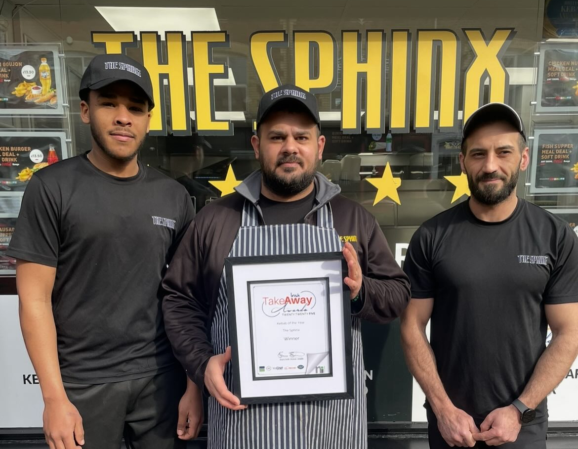 Team holding an award at The Sphinx