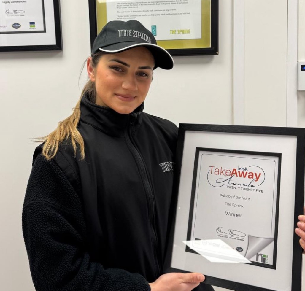 Staff member holding award