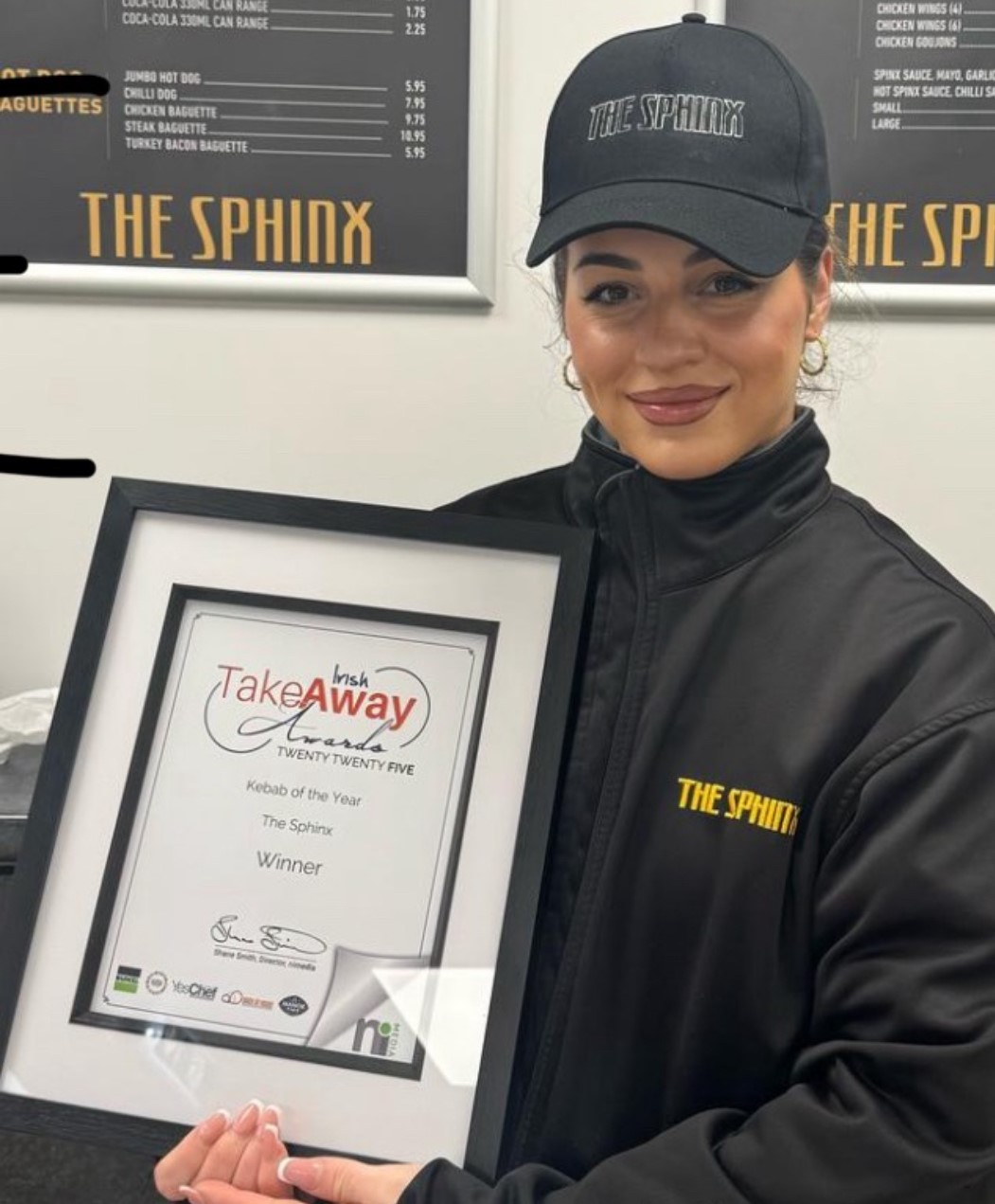 Staff member holding award